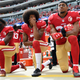 Eli Harold #58, Colin Kaepernick #7 and Eric Reid #35 of the San Francisco 49ers kneel on the sideline during the anthem prior to the game against the Dallas Cowboys at Levi’s Stadium on October 2, 2016 in Santa Clara, California.